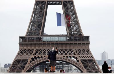 epa08414673 A nun wearing a protective facial mask takes a selfie at Trocadero near the Eiffel Tower in Paris, France, 11 May 2020. France began a gradual easing of its lockdown measures and restrictions amid the COVID-19 pandemic.  EPA/IAN LANGSDON