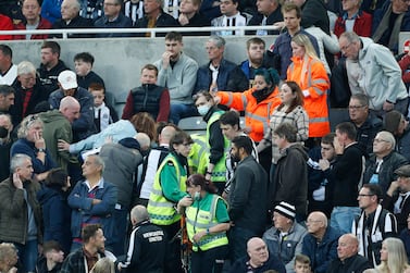 Soccer Football - Premier League - Newcastle United v Tottenham Hotspur - St James' Park, Newcastle, Britain - October 17, 2021 Newcastle fan in the stand is given emergency medical help Action Images via Reuters/Lee Smith EDITORIAL USE ONLY.  No use with unauthorized audio, video, data, fixture lists, club/league logos or 'live' services.  Online in-match use limited to 75 images, no video emulation.  No use in betting, games or single club /league/player publications.   Please contact your account representative for further details. 