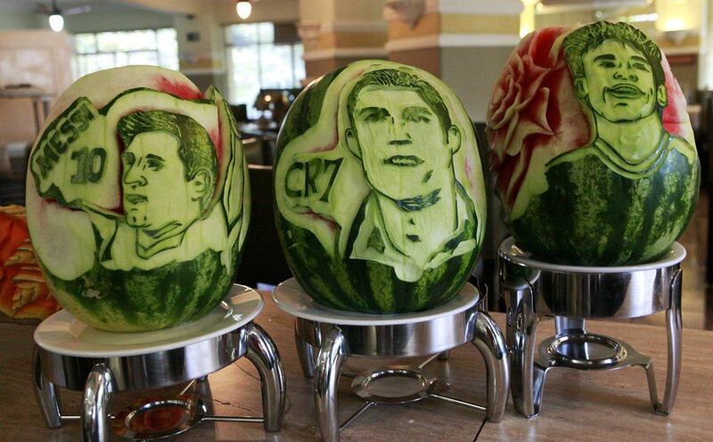 Watermelons with portraits of Lionel Messi, left, Cristiano Ronaldo, centre, and Neymar, right, carved into them by chef Rogerio Holanda at the San Raphael Hotel in Sao Paulo. Paulo Whitaker / Reuters