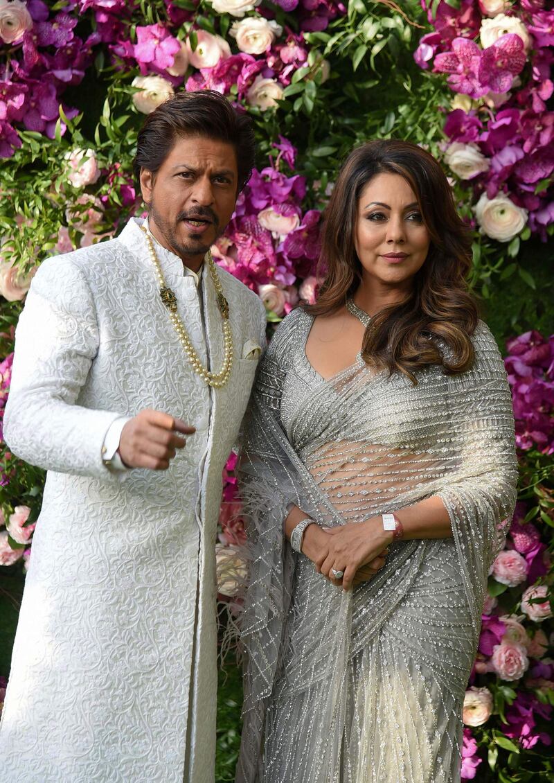 Bollywood actor Shah Rukh Khan (L) poses for photographs along with his wife and film producer Gauri Khan as they arrive to attend the wedding ceremony of Akash Ambani, son of Indian businessman Mukesh Ambani, in Mumbai on March 9, 2019. Photo: AFP