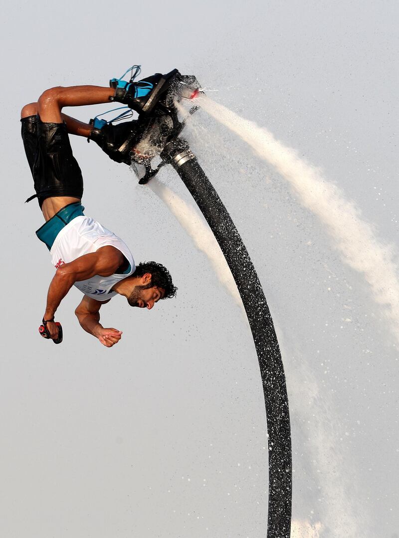 People compete in the flyboard section of the Dubai Watersports Summer Week.