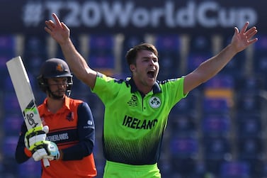 Ireland's Curtis Campher (R) celebrates after taking the wicket of Netherland's Scott Edwards during the ICC men’s Twenty20 World Cup cricket match between Ireland and Netherlands at the Sheikh Zayed Stadium in Abu Dhabi on October 18, 2021.  (Photo by INDRANIL MUKHERJEE  /  AFP)