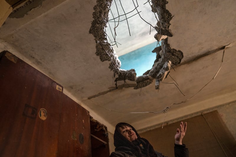 Halyna Falko, 52, talks to reporters while looking at the destruction caused after a Russian attack inside her house near Brovary, on the outskirts of Kyiv. AP Photo