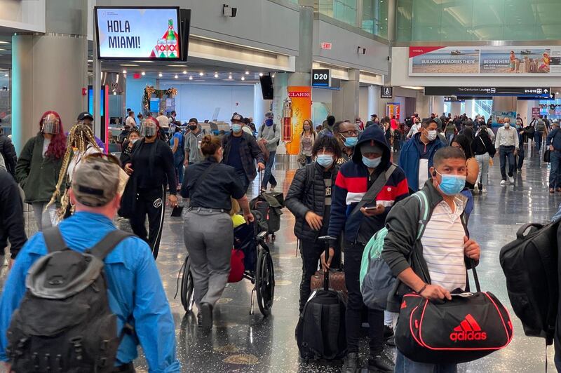 Travellers wear facemasks at Miami International Airport. AFP