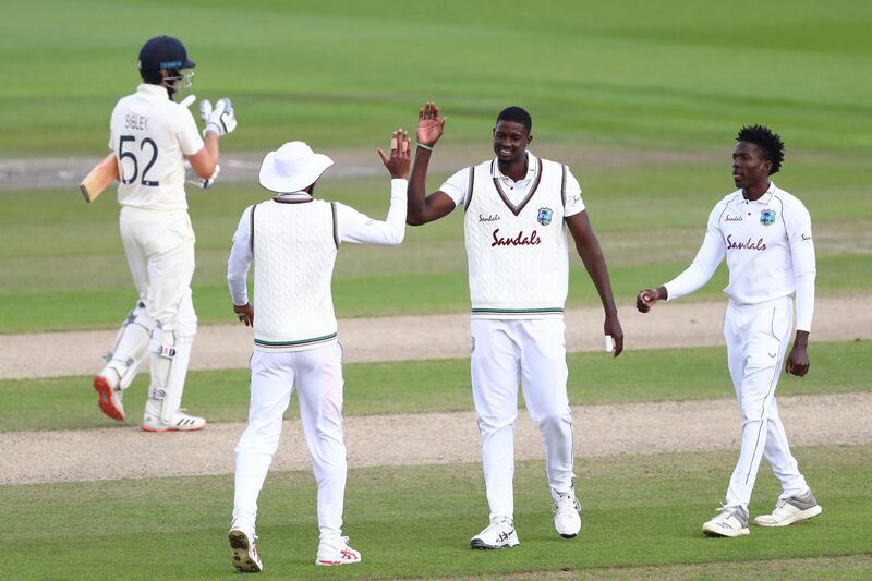 West Indies bowler Jason Holder, centre, celebrates the wicket of England's Dom Sibley. AFP
