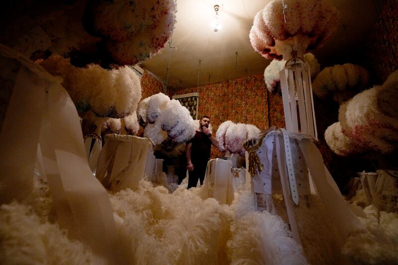 Quentin Kersten in a room full of ostrich feather hats at the family costume workshop in Binche, Belgium. AP