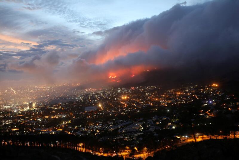Flames are seen close to the city fanned by strong winds after  a bushfire  broke out on the slopes of Table Mountain in Cape Town, South Africa, April 19, 2021. REUTERS/Mike Hutchings     TPX IMAGES OF THE DAY