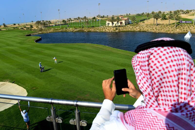 A Saudi golf enthusiasts watches the action at the Saudi Ladies International. AFP