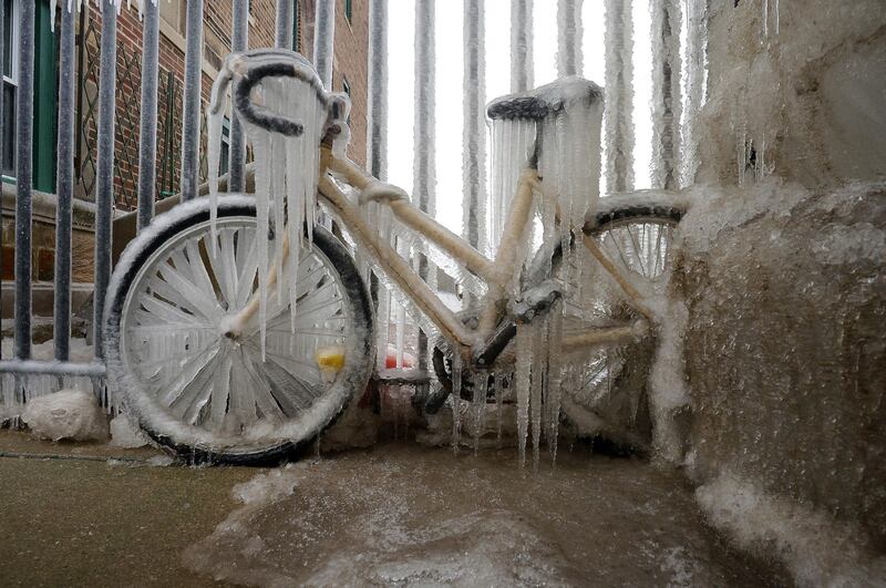 A bicycle is covered in a thick layer of ice near East 73th Street in Chicago, USA. Chicago Sun-Times via AP
