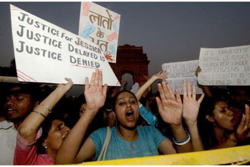 Activists shout slogans and wave placards in 2006, demanding a retrial after nine men were acquitted in the death of Jessica Lal.