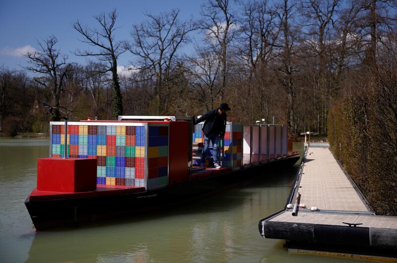 A pilot steers a scaled-down model of an ULCS container ship, named the Spirit of Port Revel, on a lake at the Port Revel Shiphandling Training Centre in Saint-Pierre-de-Bressieux, France, April 19, 2021. Picture taken April 19, 2021. REUTERS/Stephane Mahe