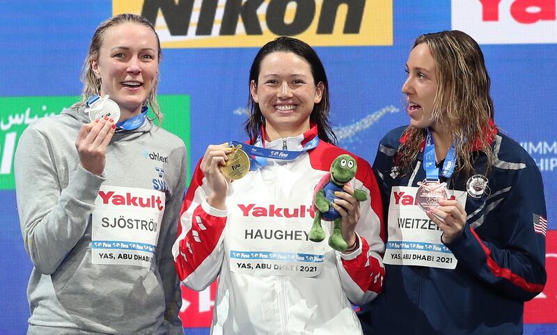 Gold medalist Siobhan Haughey, centre, alongside Sarah Sjostrom, left, who took silver and bronze winner Abbey Weitzeil after the women's 100m freestyle final at the Fina World Swimming Championships in Abu Dhabi. EPA
