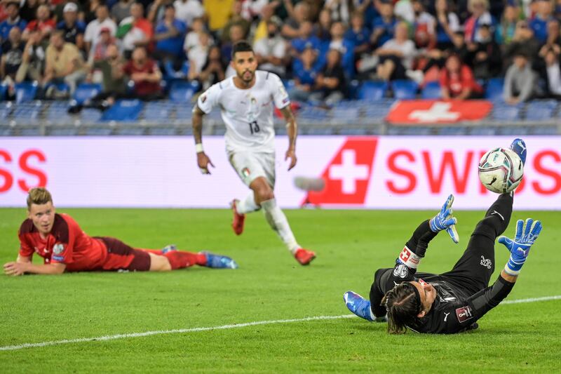 Switzerland goalkeeper Yann Sommer, right, saves a shot next to Italy's Emerson. AP