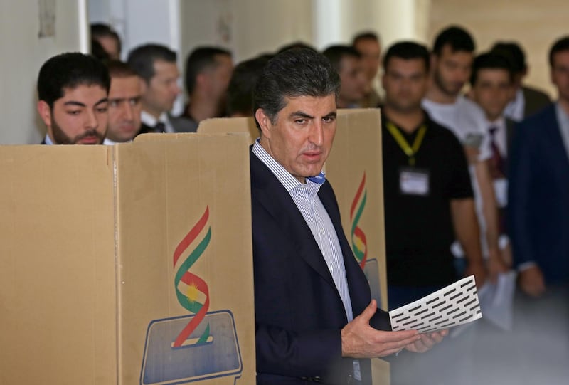 Prime Minister of Iraqi Kurdistan Nechirvan Barzani, centre, votes in the Kurdistan parliamentary election at a polling station in Erbil, the capital of the Kurdistan Region in Iraq.  EPA