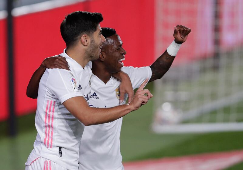 Real Madrid's Vinicius Junior, right, celebrates with his teammate Marco Asensio after scoring against  Valladolid at Alfredo di Stefano stadium in Madrid. AP