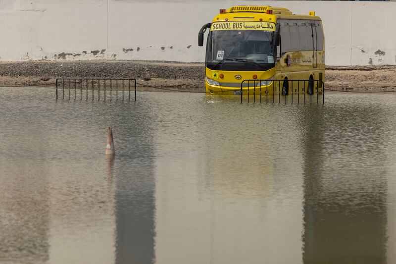 School buses on hand to drive pupils through the water after the flood. Antonie Robertson / The National