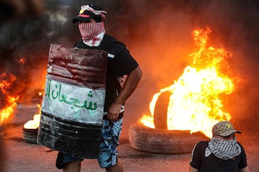 Protesters set tyres on fire during an anti-government protest outside the provincial council building in Basra, Iraq, on Monday, August 17, 2020. AP