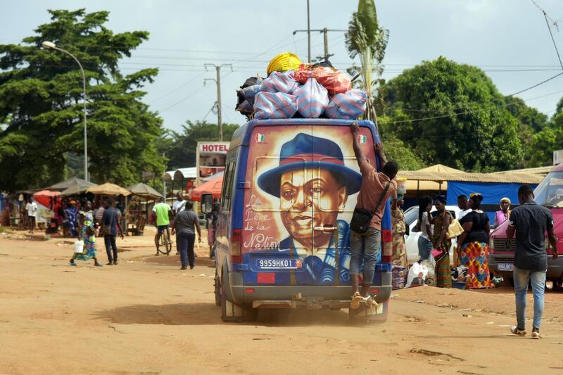 A van with a mural of former Ivorian President Felix Houphouet-Boigny painted on its back pass in a street in Yamoussoukro, Ivory Coast. AFP