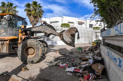 A bulldozer clears debris from a migrant camp near the offices of the International Organisation for Migration in Tunis. AFP