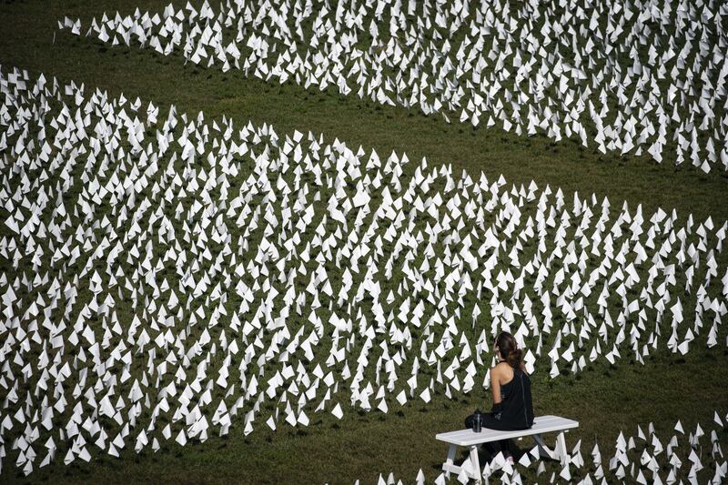 A woman sits on a bench at a public art installation near the Washington Monument.  AFP