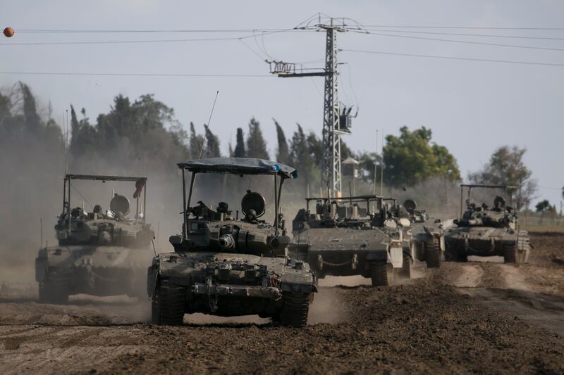 Israeli tanks and armoured personnel carriers i southern Israel on the border with the Gaza Strip on Wednesday. Getty Images