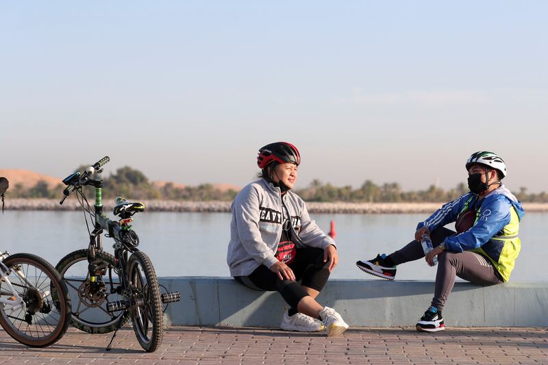 Residents enjoy exercising outdoors during the cooler months but still need to wrap up against the cold. Khushnum Bhandari / The National