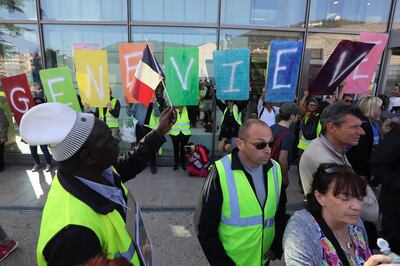 Protesters hold placards with letters spelling "Genevieve" in front of the Pasteur University Hospital in Nice, in March 2019. AFP