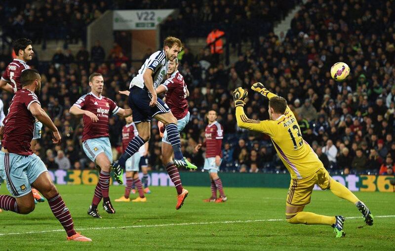 Craig Dawson of West Brom heads and scores the opening goal past Adrian of West Ham during his side's 2-1 loss on Tuesday in the Premier League. Ross Kinnaird / Getty Images