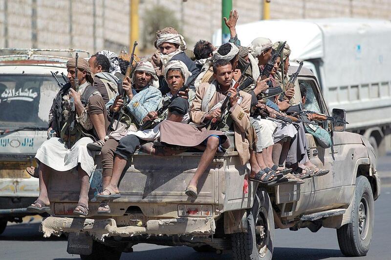 Armed Yemeni Shiite Houthi anti-government rebels travel in the back of a pickup truck on Sunday in the capital Sanaa. Mohammaed Huwais / AFP  