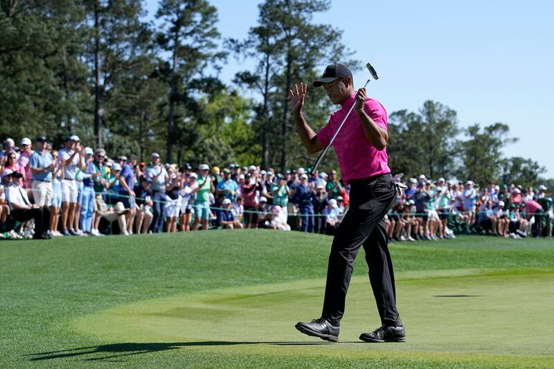 Tiger Woods acknowledges applause on the 18th green. AP