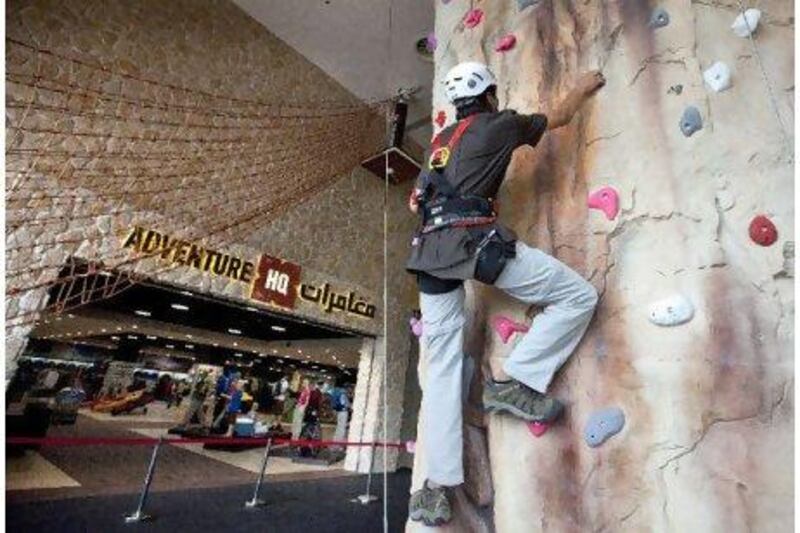 Experts say there are serious regulatory problems with climbing gyms in the UAE. Above, a worker from Adventure HQ climbs the nine-metre wall at the Times Square Mall in Dubai that a Jordanian man fell from this month, breaking both his legs and an arm..