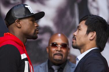 FILE PHOTO: ON THIS DAY -- April 29 April 29, 2015 BOXING - Undefeated WBC/WBA welterweight champion Floyd Mayweather Jr of the U.S. and WBO welterweight champion Manny Pacquiao of the Philippines face off during a final news conference at the MGM Grand Arena in Las Vegas, Nevada. The two champions faced each other in a welterweight unification bout that was dubbed the "Fight of the Century" on May 2 where Mayweather's defensive brilliance trumped Pacquiao's all-out attack as the American won on a unanimous decision. The fight generated record pay-per-view revenue in the United States of $400 million from 4.4 million buys, with the majority of the revenue going to the boxers and Mayweather taking the larger share. REUTERS/Steve Marcus/File Photo