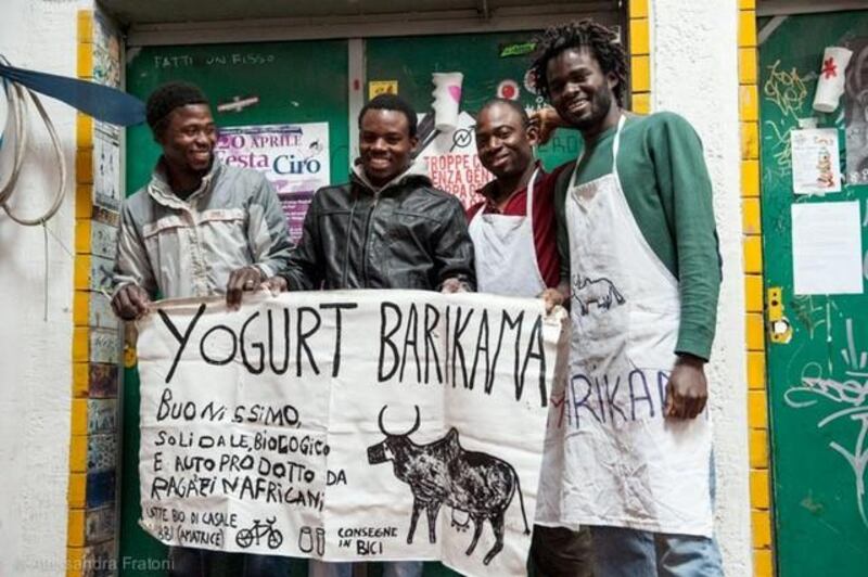 Suleman Diara, right, the founder of Barikama, with his friends. Barikama started with a €30 loan, and now sells 400 litres of yoghurt a day. Alessandro Fratoni