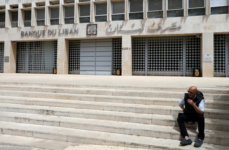 FILE PHOTO: A man sits on steps in front of the Central Bank in Beirut, Lebanon May 7, 2019. REUTERS/Mohamed Azakir/File Photo
