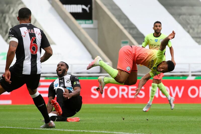 Manchester City's Brazilian striker Gabriel Jesus goes down in a challenge with Newcastle defender Danny Rose. AFP