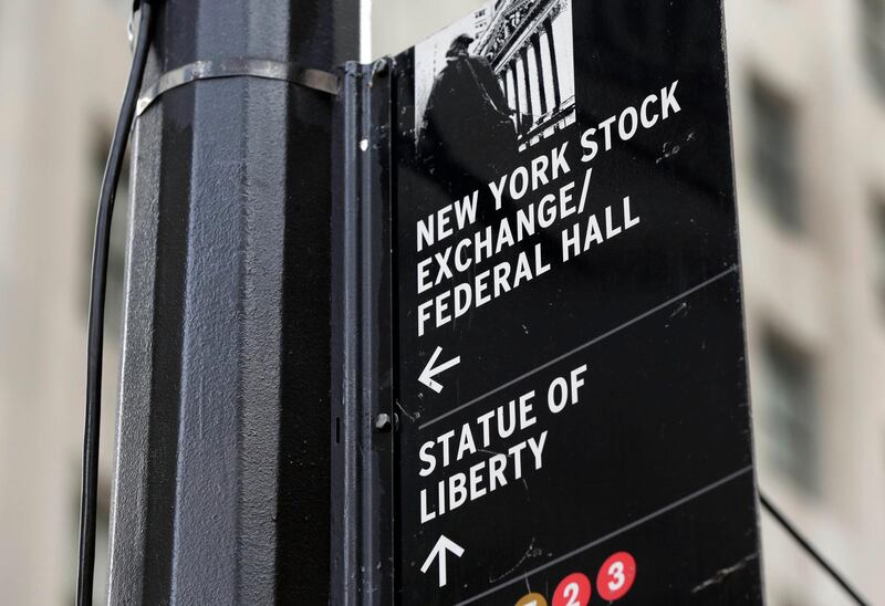 FILE - In this Thursday, Oct. 2, 2014, file photo, a street sign directs people to the New York Stock Exchange, Federal Hall, and the Statue of Liberty, in New York's Financial District. Gains by technology companies and banks helped lift U.S. stocks higher in early trading Thursday, Dec. 14, 2017. (AP Photo/Richard Drew, File)