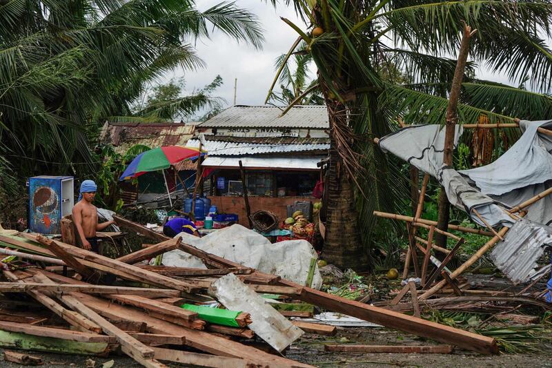 A resident looks at a house damaged at the height of Typhoon Phanfone in Tacloban, Leyte province in the central Philippines.  AFP