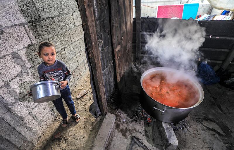 A Palestinian girl waits for food. EPA
