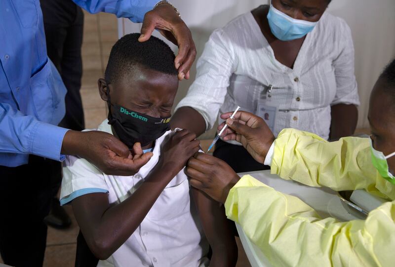 A child receives his Pfizer-BioNTech vaccine against Covi-19 in Diepsloot township near Johannesburg. AP 