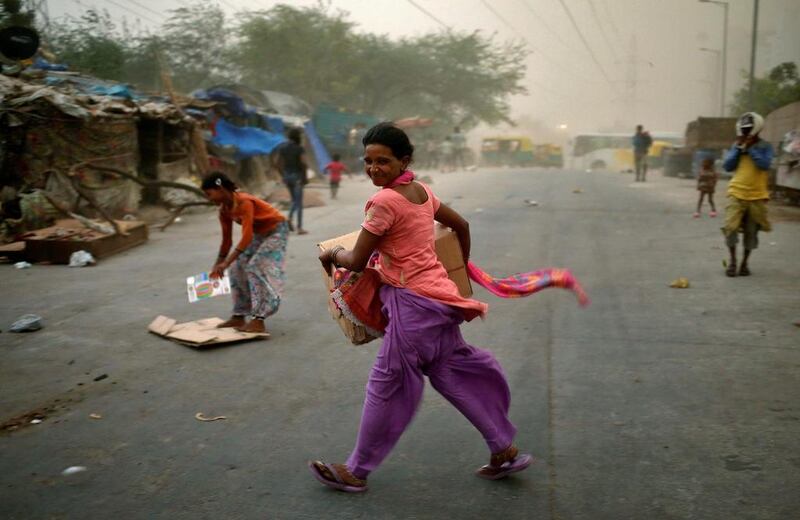 People are caught in a dust storm in New Delhi.  Anindito Mukherjee / Reuters