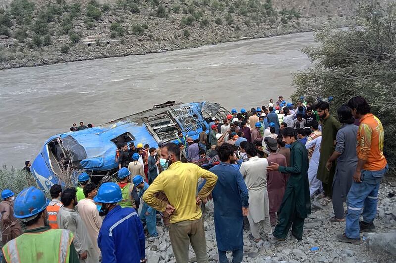 Rescuers and onlookers gather around the wreck of a bus that plunged into a ravine following a bomb explosion which killed 12  in Khyber Pakhtunkhwa province, Pakistan.