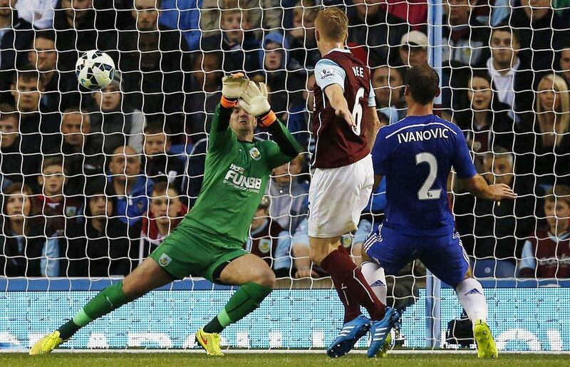 Chelsea's Branislav Ivanovic, right, scores their third goal past Burnley's Tom Heaton in their 3-1 Premier League victory on Monday night. Andrew Yates / Reuters 