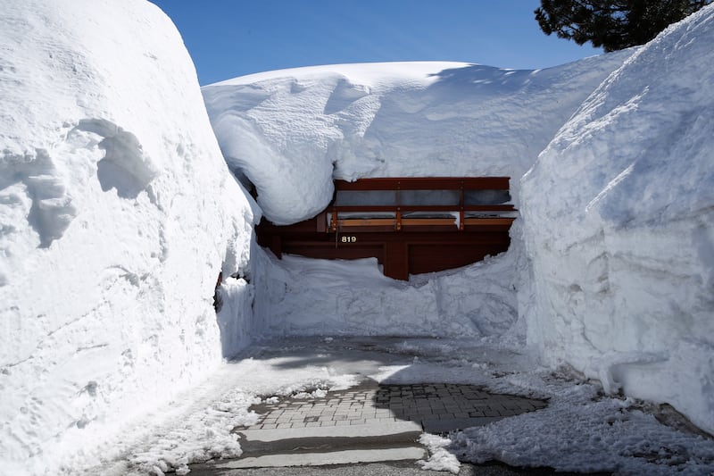 A house is covered with snow after a storm in Mammoth Lakes, California. EPA 