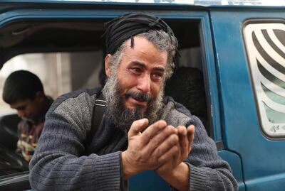 TOPSHOT - Abu Ahmad, one of the last people to flee from Maaret al-Numan in the northwestern Syrian Idlib province, reacts as he rides in a pick-up truck before leaving the town with his family towards a camp for the displaced, on December 24, 2019. Syrian government forces on December 24 were less than four kilometres (two miles) from the strategic city of Maaret al-Numan, the head of the Britain-based monitor, Rami Abdel Rahman, told AFP. Fearing further advances, thousands of Maaret al-Numan's residents have fled.  / AFP / Omar HAJ KADOUR
