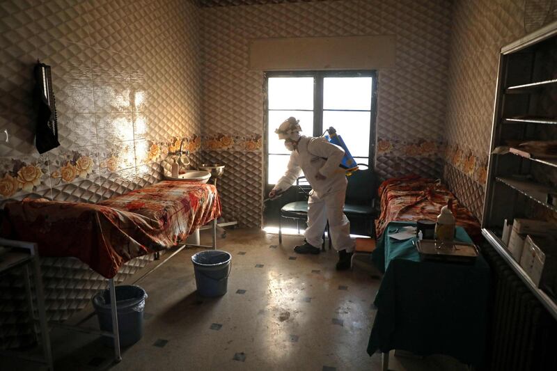 A member of the Syrian Civil Defence known as the "White Helmets" disinfects a hospital room, as part of preventive measures taken against infections by the novel coronavirus, in the Syrian town of Dana, east of the Turkish-Syrian border in the northwestern Idlib province, on March 22, 2020.  Unlike Syria, its five neighbours, Iraq, Israel, Jordan, Lebanon and Turkey, have all reported cases of coronavirus.
The rebel-held and densely-populated province of Idlib in northwest Syria, besieged by government forces and facing severe shortages of medical supplies and facilities, would suffer the most from an outbreak.
 / AFP / AAREF WATAD
