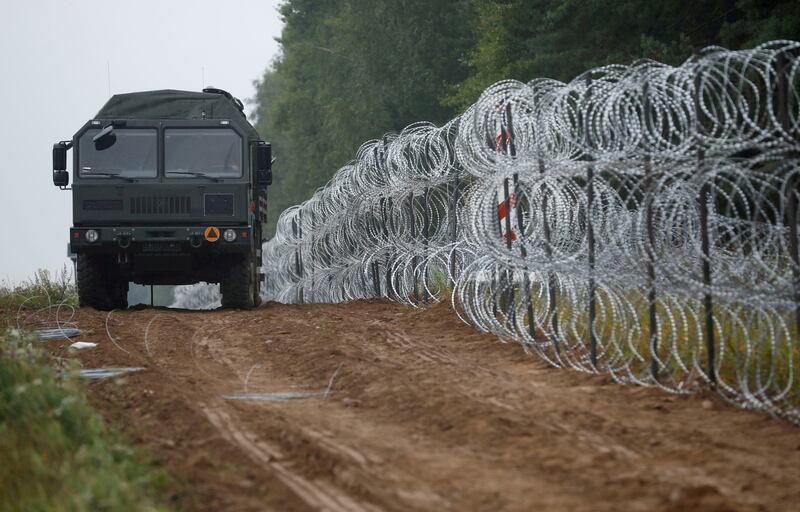 A fence built by Polish soldiers on the border with Belarus near the village of Nomiki. Photo: Reuters