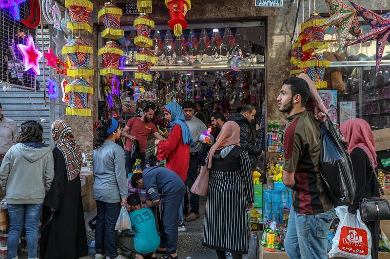 Palestinians shop in the market before the holy month of Ramadan in Gaza City.  EPA