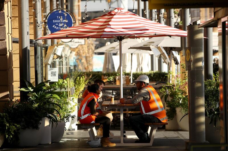 People enjoy a coffee outside at the Fullers Fery terminal in Auckland, New Zealand. Getty Images