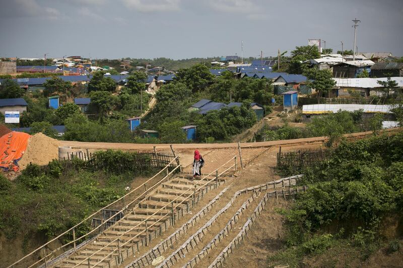 A woman walks down a stairway in a refugee camp in Cox's Bazar. Getty Images