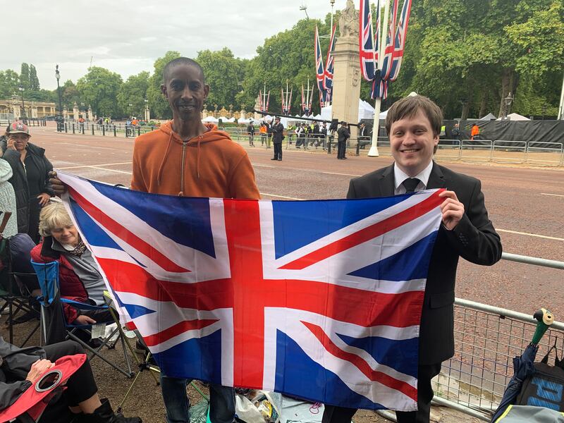 Bertrand Philibert from Mauritius, left, with fellow royal fan Lewis from Newcastle wait on The Mall before the ceremonial procession. Photo: The National